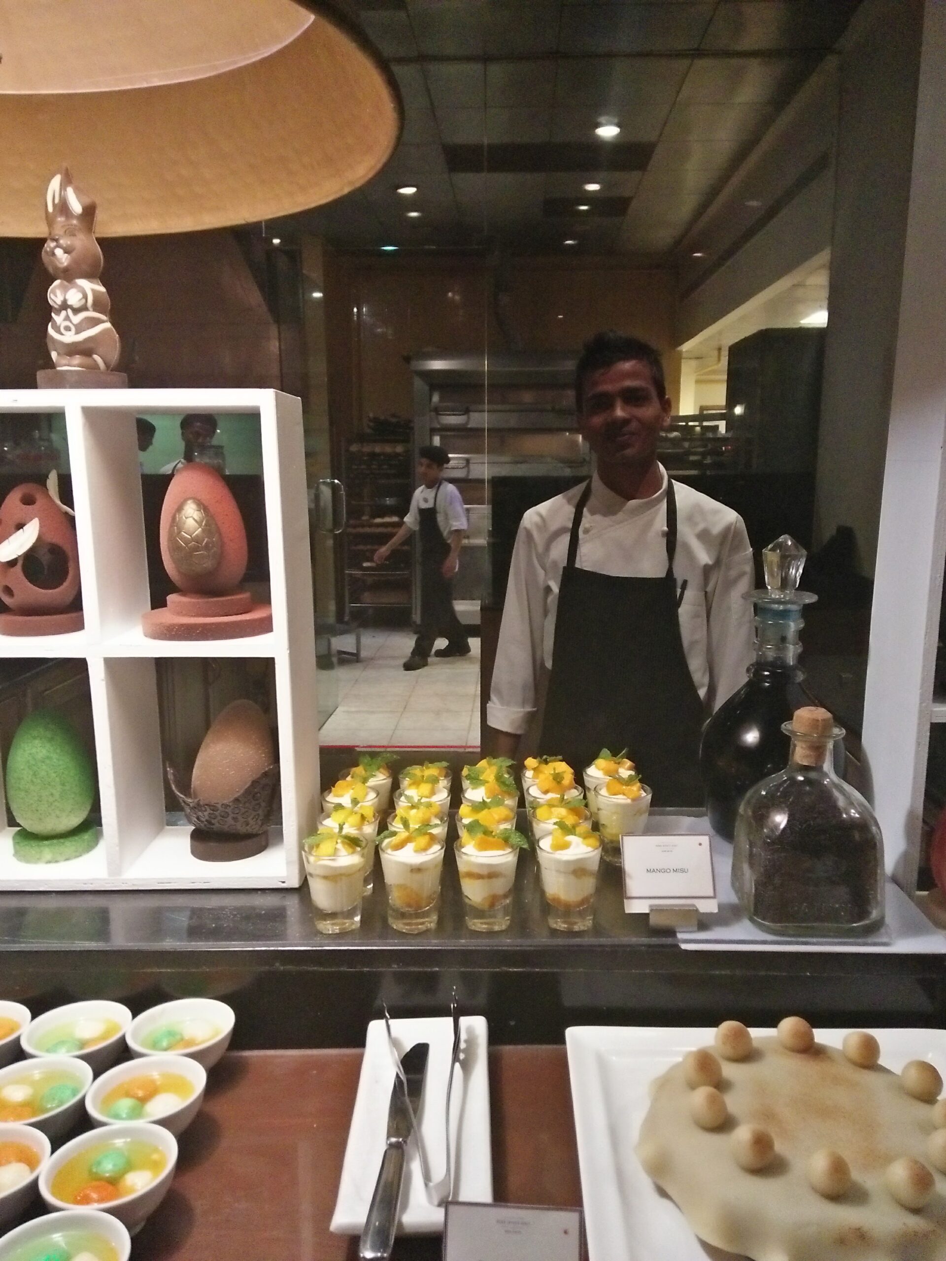 Chef behind an elaborate hotel pastry buffet in Goa — the result of early morning kitchen work
