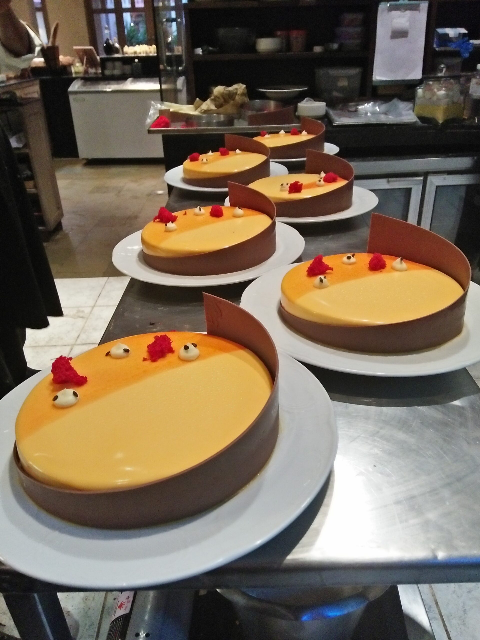Professional hotel pastry kitchen with clean workstation and plated desserts
