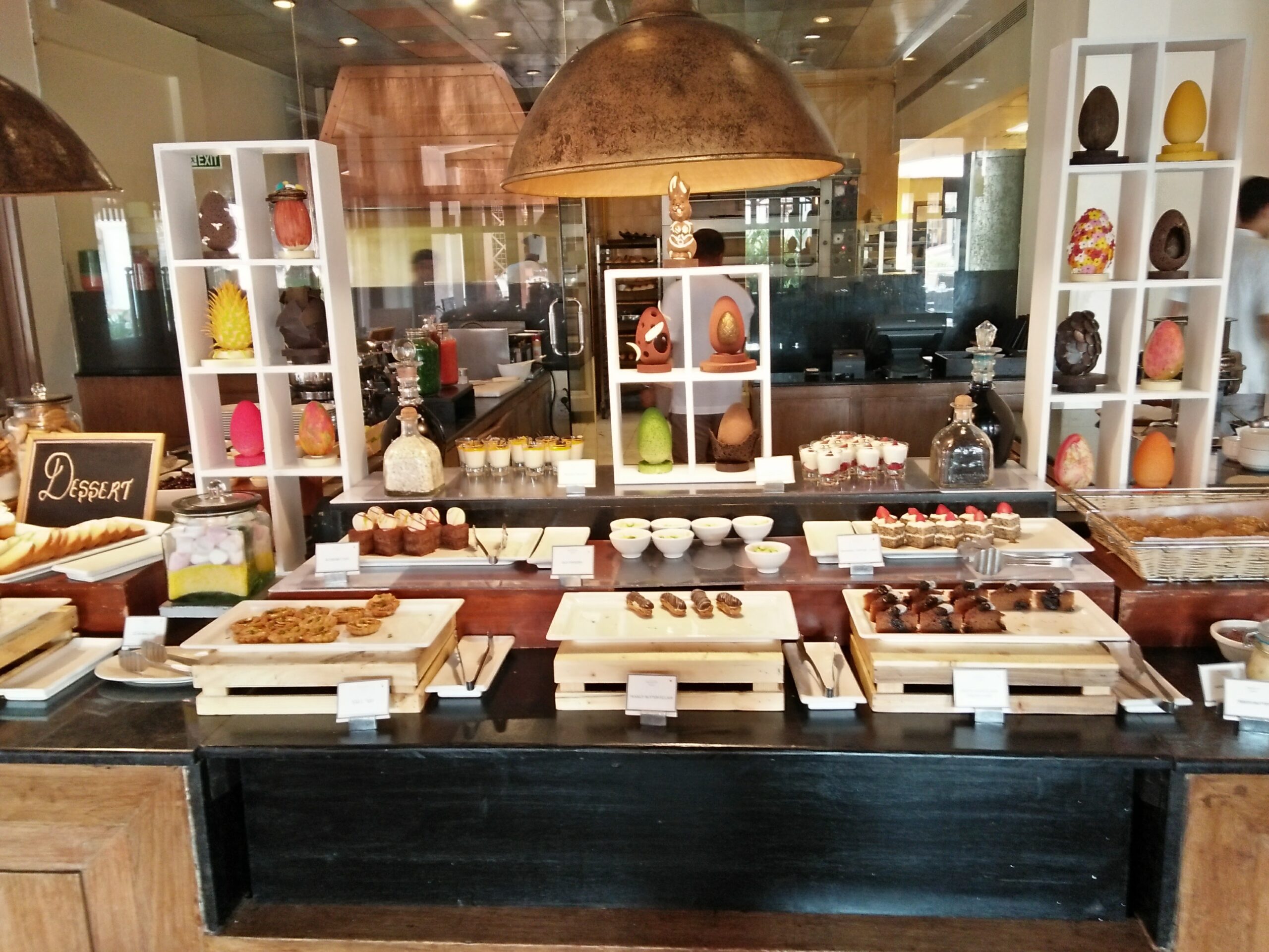 Organised hotel pastry buffet showing professional food storage and display