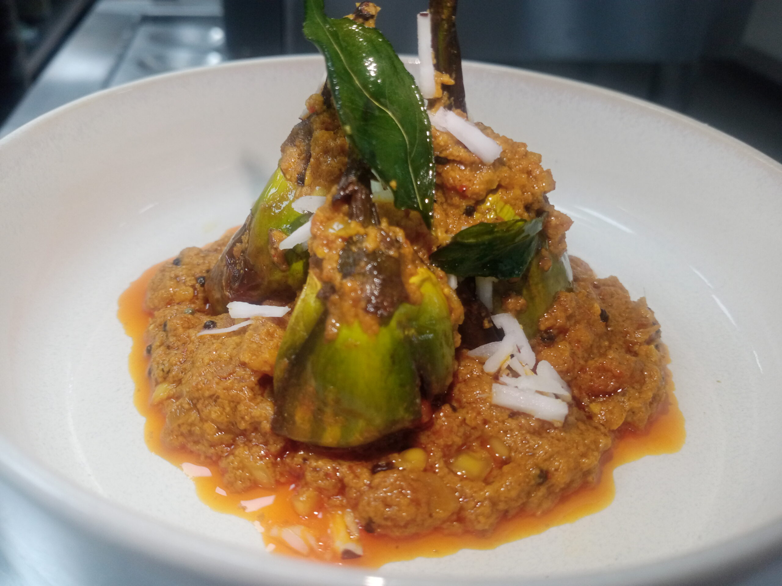 Stuffed baby eggplant showing precise vegetable prep and knife work in Indian cooking