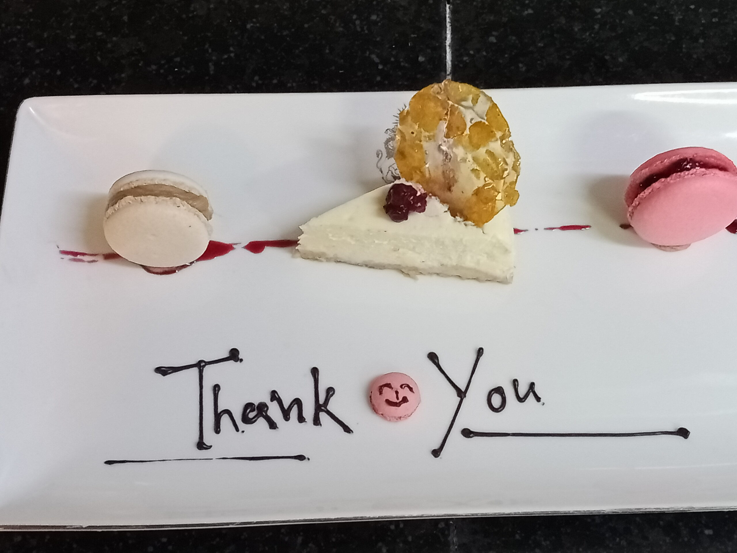 Elegant plated cheesecake with macarons — modern interpretation of a classic dessert